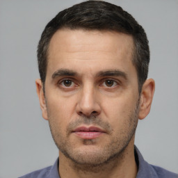 Neutral white adult male with short  black hair and brown eyes