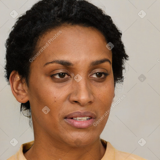 Joyful black adult female with short  brown hair and brown eyes