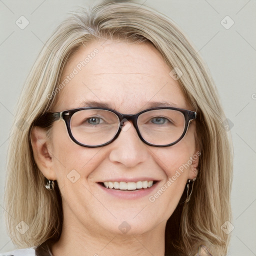 Joyful white adult female with medium  brown hair and blue eyes