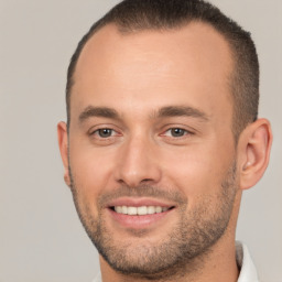 Joyful white young-adult male with short  brown hair and brown eyes