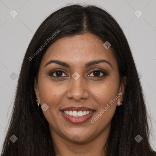 Joyful black young-adult female with long  brown hair and brown eyes