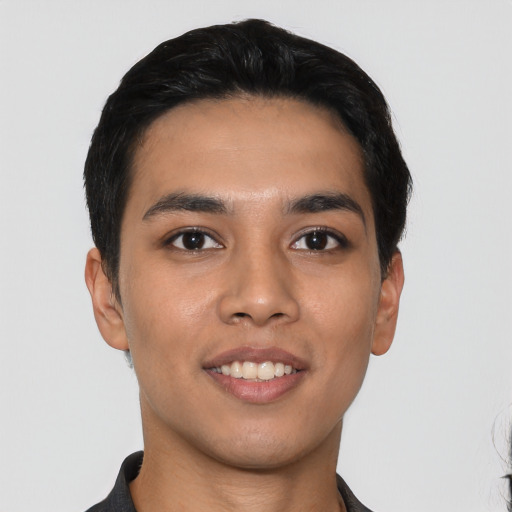 Joyful latino young-adult male with short  black hair and brown eyes