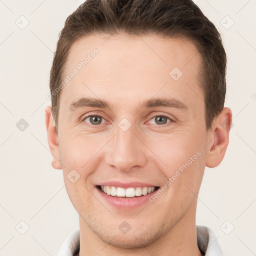 Joyful white young-adult male with short  brown hair and brown eyes