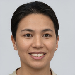 Joyful asian young-adult female with short  brown hair and brown eyes