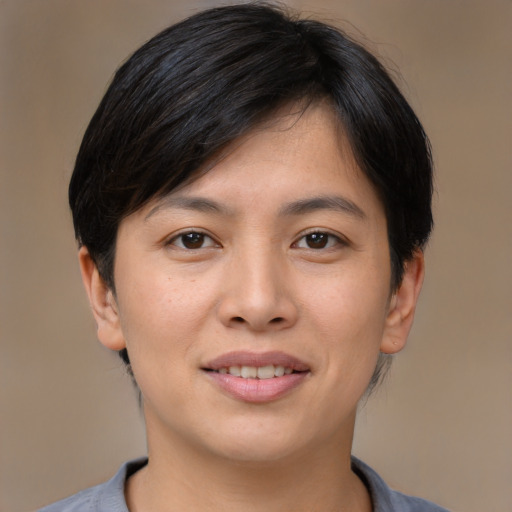 Joyful asian young-adult female with short  brown hair and brown eyes