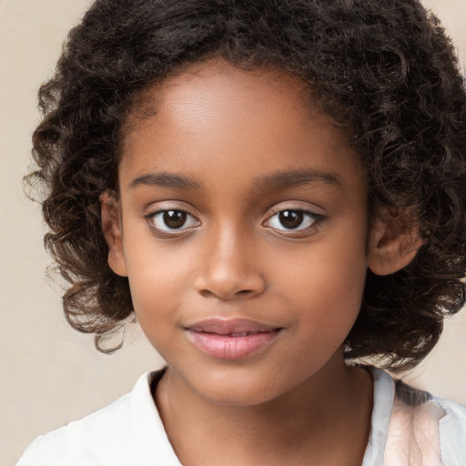 Joyful black child female with medium  brown hair and brown eyes