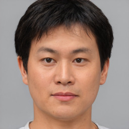 Neutral asian young-adult male with short  brown hair and brown eyes