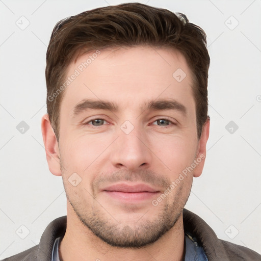 Joyful white young-adult male with short  brown hair and grey eyes