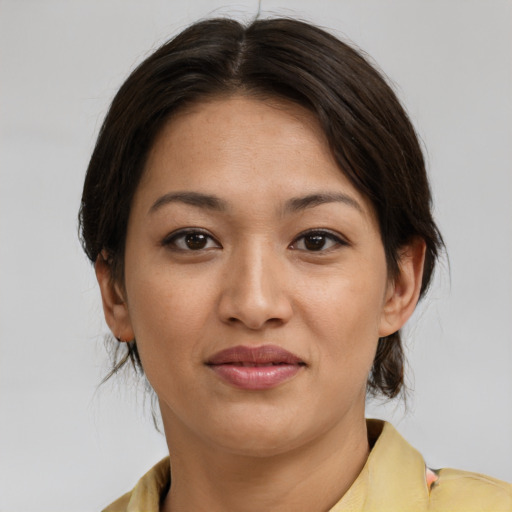 Joyful asian young-adult female with medium  brown hair and brown eyes