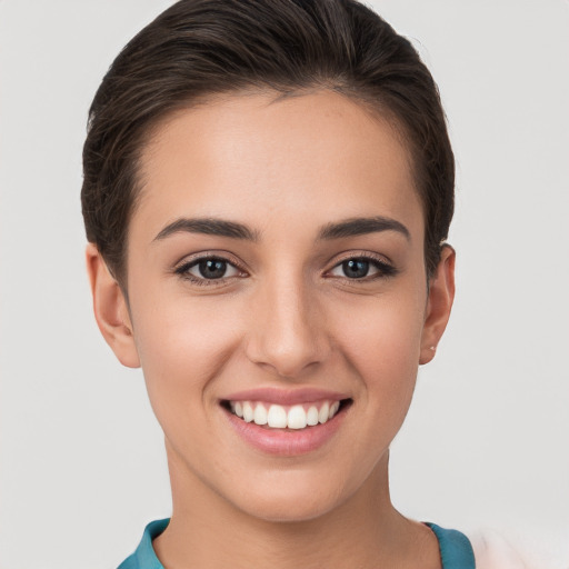 Joyful white young-adult female with short  brown hair and brown eyes