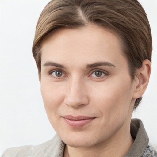 Joyful white young-adult female with short  brown hair and grey eyes