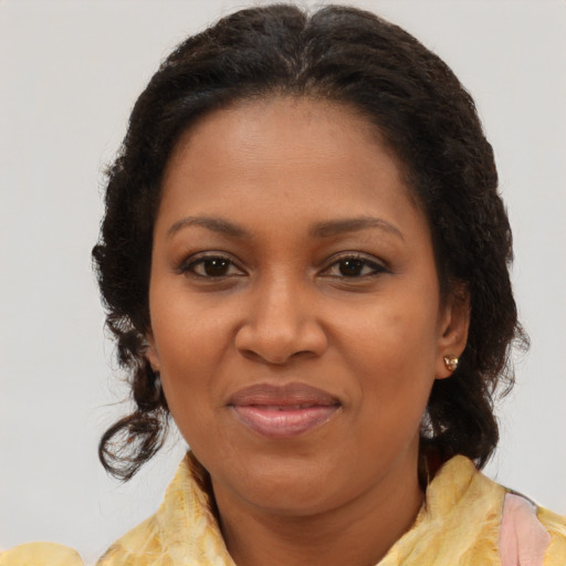 Joyful black young-adult female with medium  brown hair and brown eyes