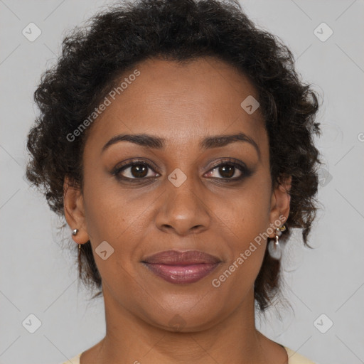 Joyful black adult female with short  brown hair and brown eyes