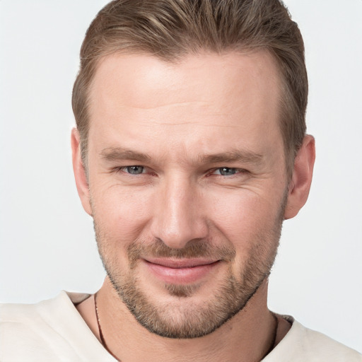 Joyful white young-adult male with short  brown hair and grey eyes