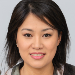 Joyful asian young-adult female with medium  brown hair and brown eyes