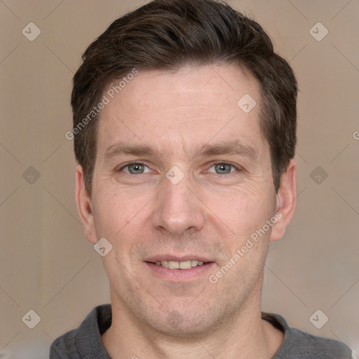 Joyful white adult male with short  brown hair and grey eyes