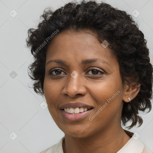 Joyful black young-adult female with long  brown hair and brown eyes