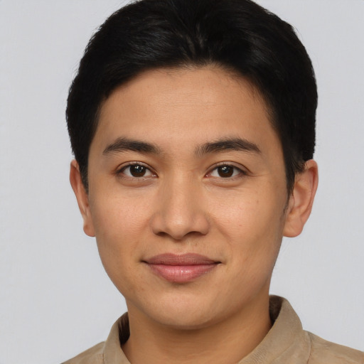 Joyful latino young-adult male with short  brown hair and brown eyes