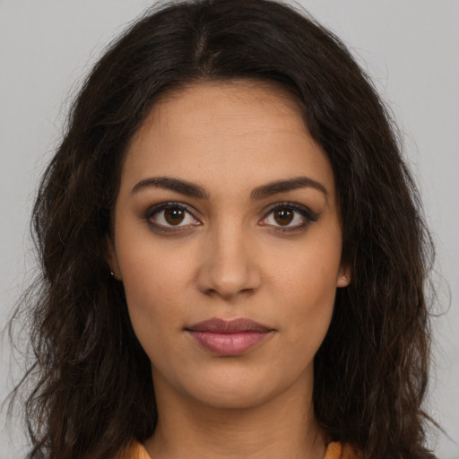 Joyful latino young-adult female with long  brown hair and brown eyes