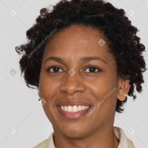 Joyful black adult female with short  brown hair and brown eyes