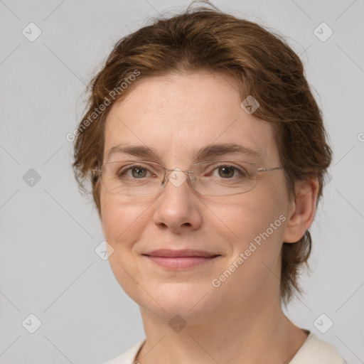 Joyful white adult female with medium  brown hair and green eyes