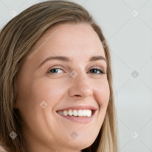 Joyful white young-adult female with long  brown hair and blue eyes