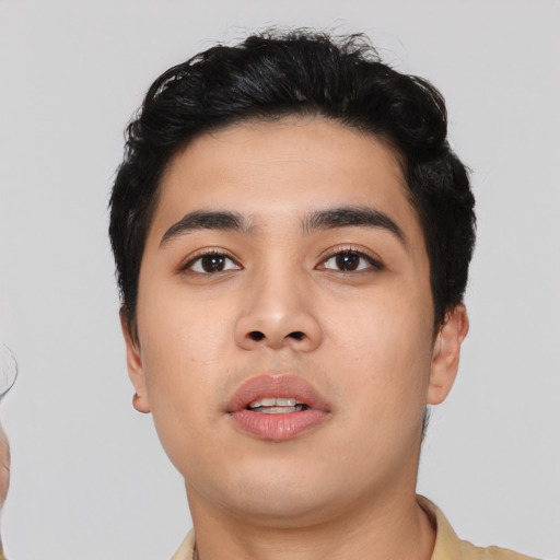 Joyful asian young-adult male with short  black hair and brown eyes