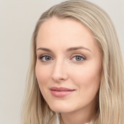 Joyful white young-adult female with long  brown hair and blue eyes