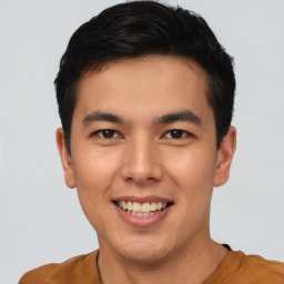 Joyful asian young-adult male with short  brown hair and brown eyes