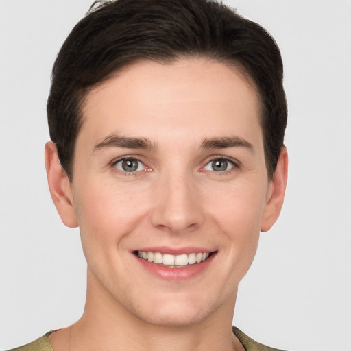 Joyful white young-adult female with short  brown hair and grey eyes