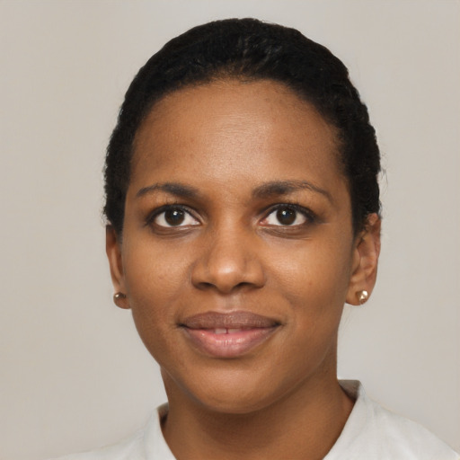 Joyful black young-adult female with short  black hair and brown eyes