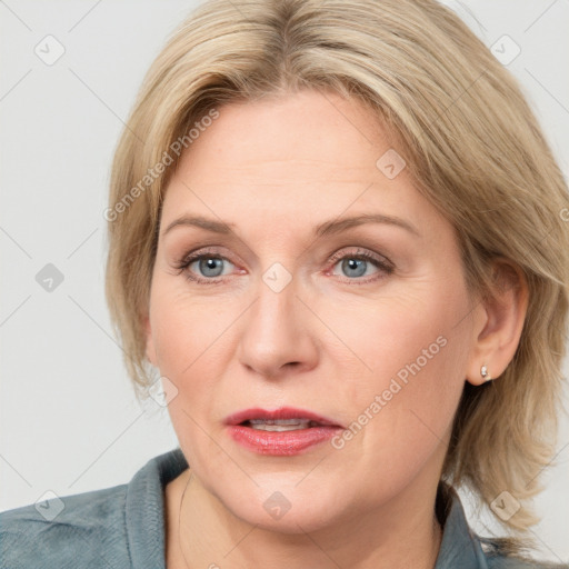 Joyful white adult female with medium  brown hair and blue eyes