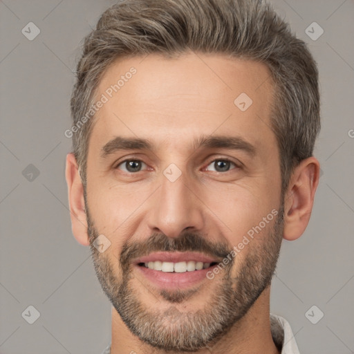 Joyful white adult male with short  brown hair and brown eyes