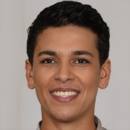 Joyful latino young-adult male with short  brown hair and brown eyes