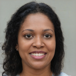 Joyful black young-adult female with medium  brown hair and brown eyes