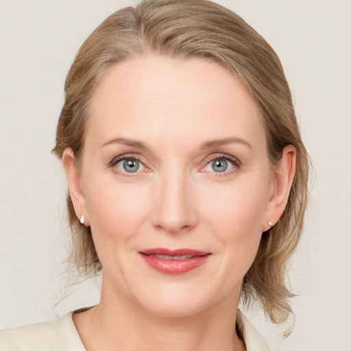 Joyful white young-adult female with medium  brown hair and blue eyes