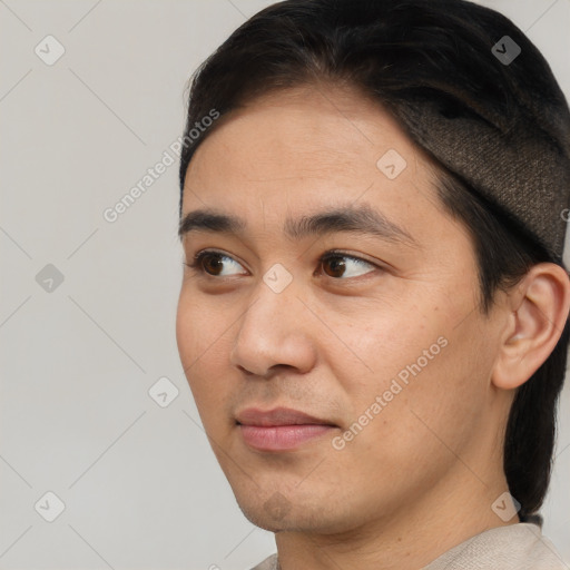 Joyful asian young-adult male with short  black hair and brown eyes