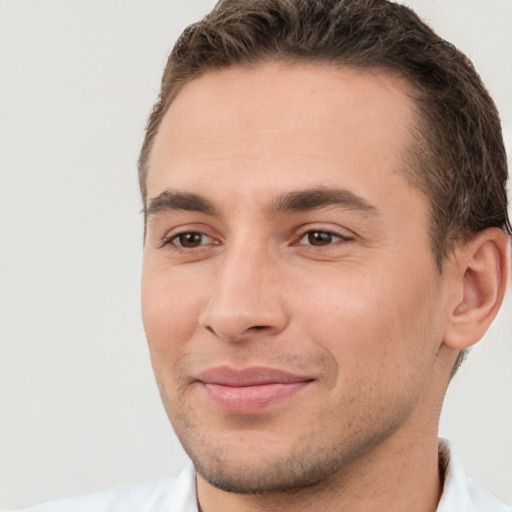 Joyful white young-adult male with short  brown hair and brown eyes