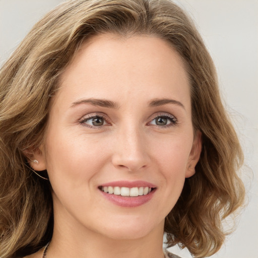 Joyful white young-adult female with long  brown hair and green eyes