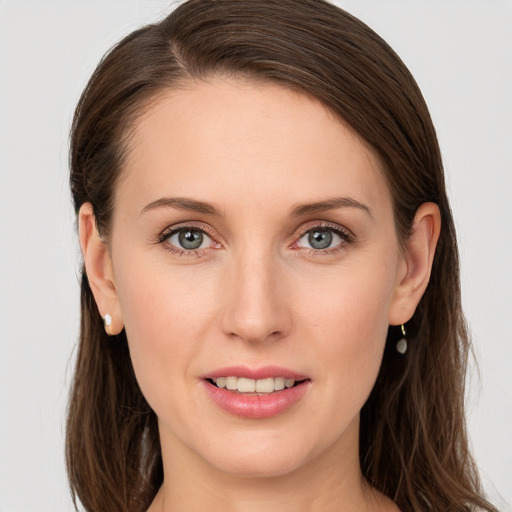 Joyful white young-adult female with long  brown hair and grey eyes