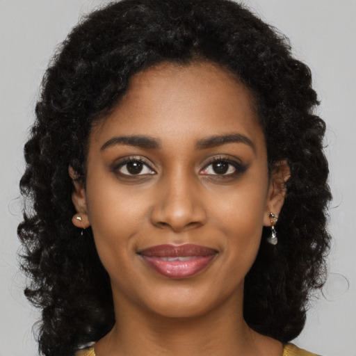 Joyful black young-adult female with medium  black hair and brown eyes