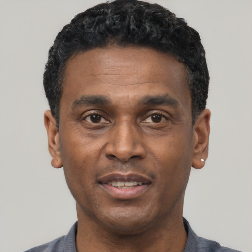 Joyful latino adult male with short  black hair and brown eyes