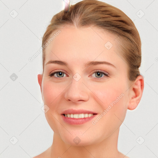 Joyful white young-adult female with short  brown hair and blue eyes