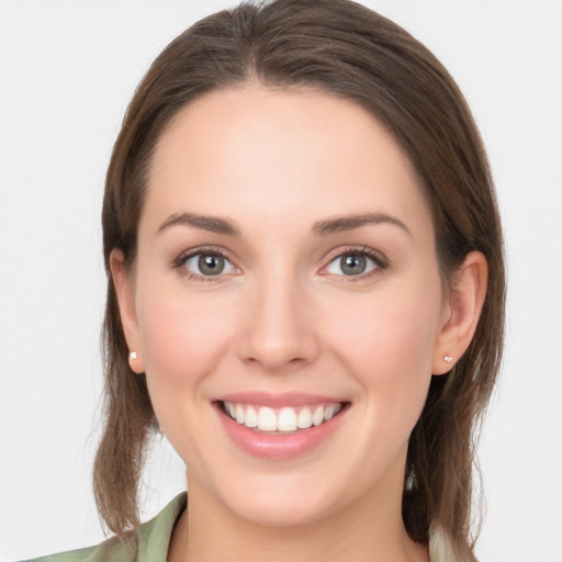 Joyful white young-adult female with long  brown hair and grey eyes