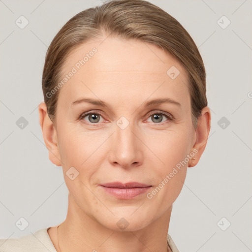 Joyful white adult female with short  brown hair and grey eyes