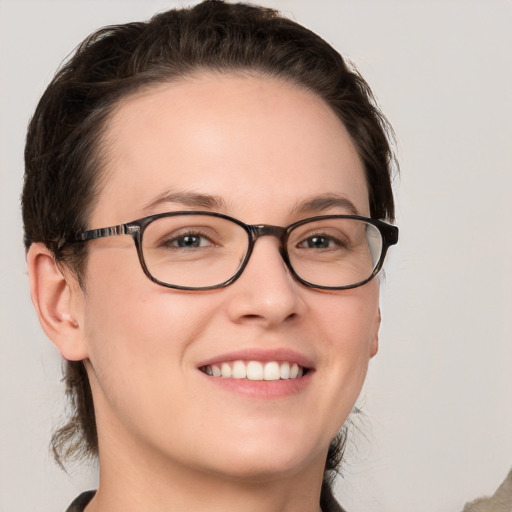 Joyful white young-adult female with medium  brown hair and grey eyes