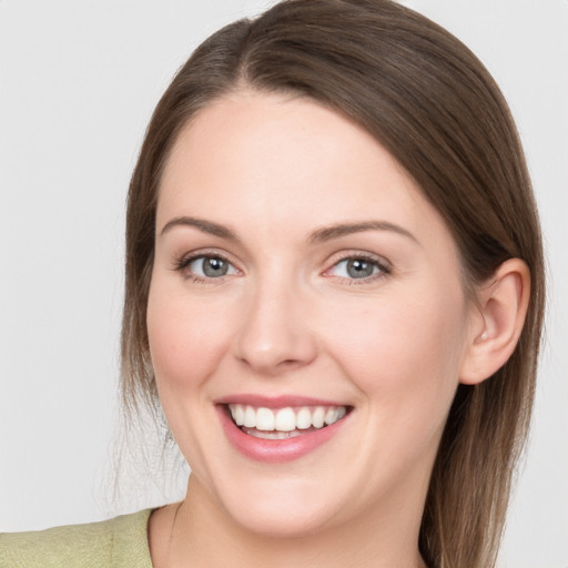 Joyful white young-adult female with long  brown hair and grey eyes