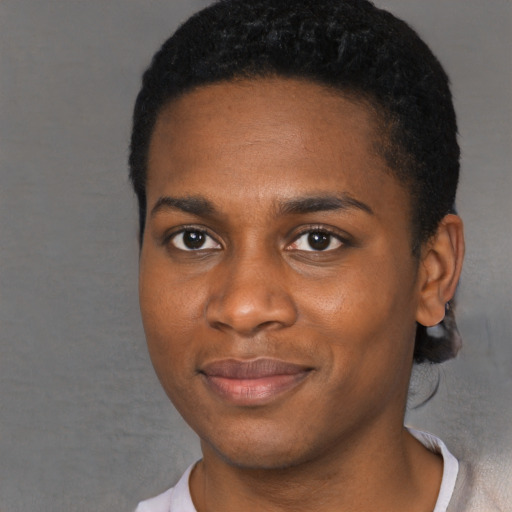 Joyful black young-adult male with short  black hair and brown eyes