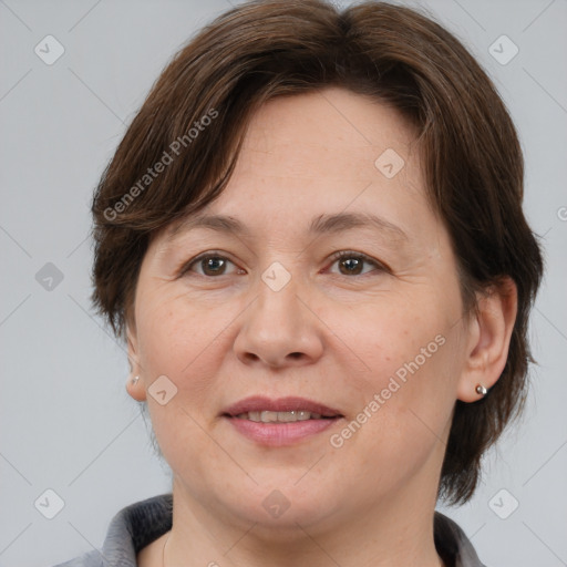 Joyful white adult female with medium  brown hair and brown eyes