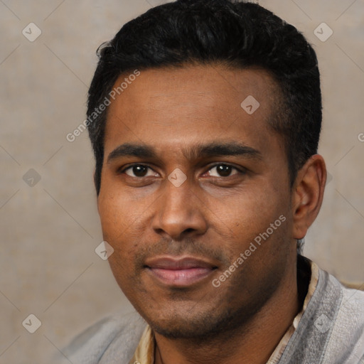 Joyful black young-adult male with short  black hair and brown eyes